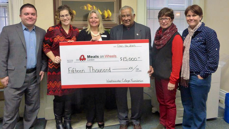 Westminster College Foundation present a cheque to Meals on Wheels London. A photo.